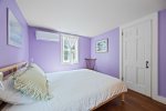 This lovely lavender room offers a queen bed